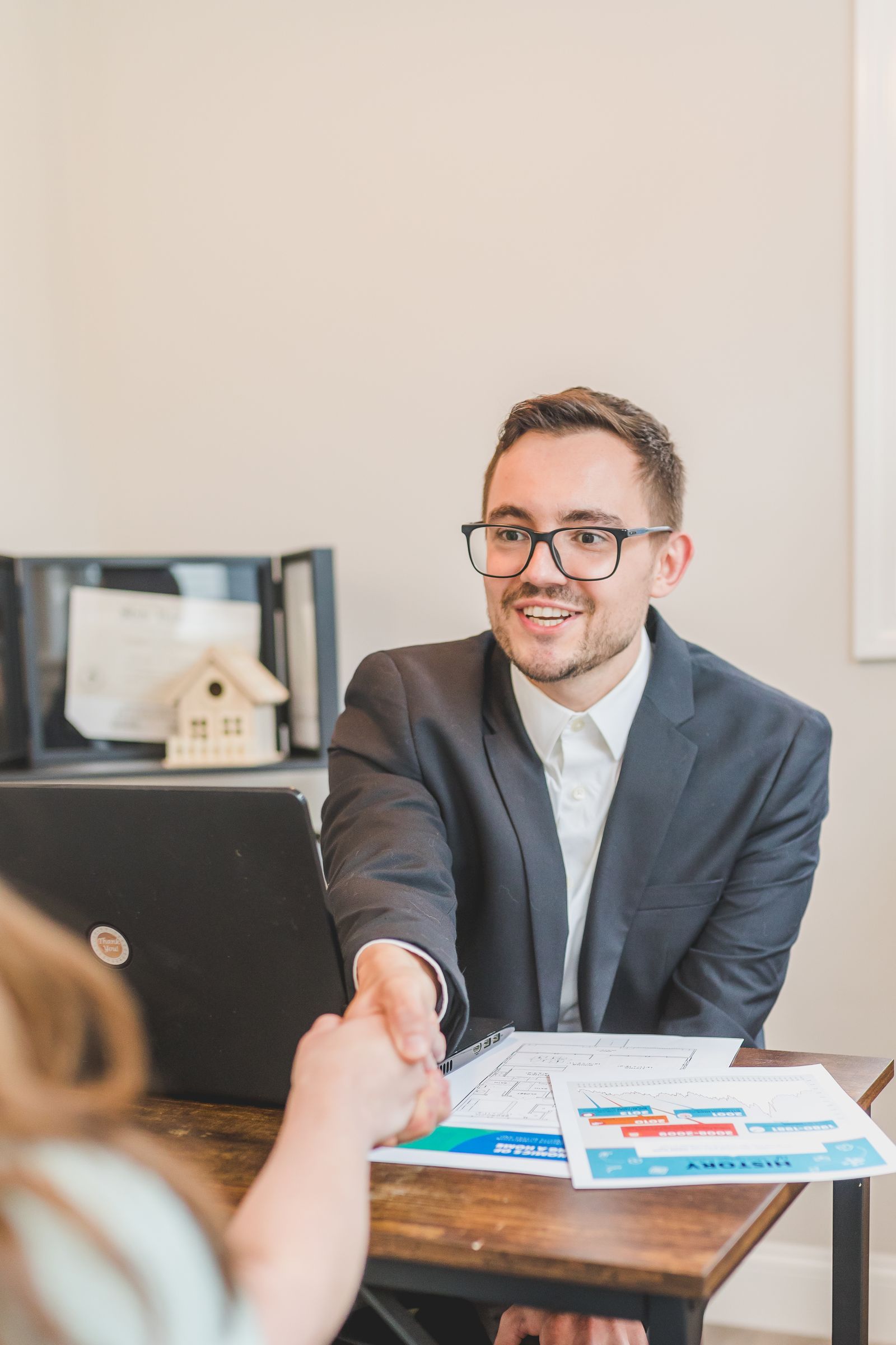 Mortgage professional shaking hands with a client