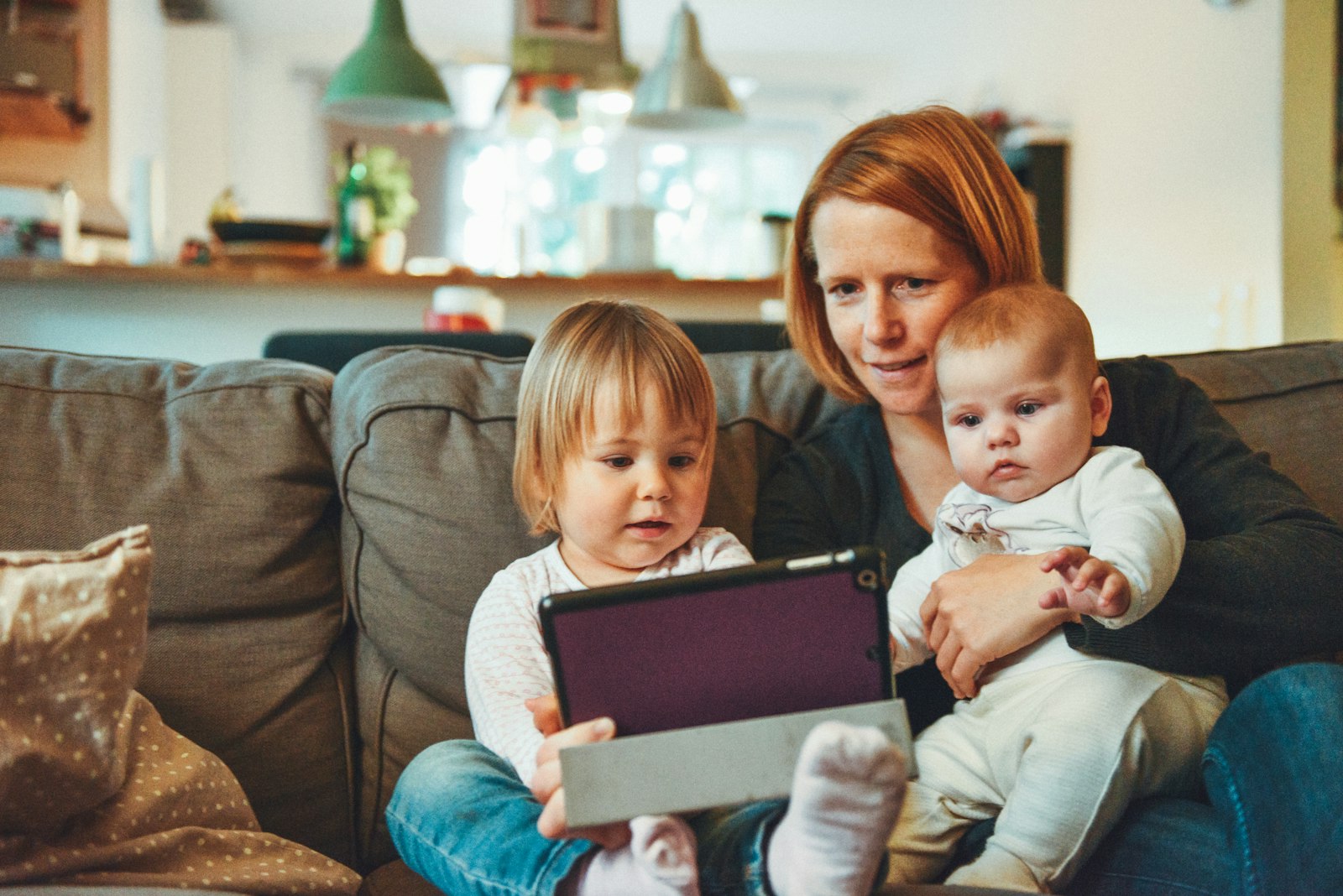 Parent and children at home on the couch