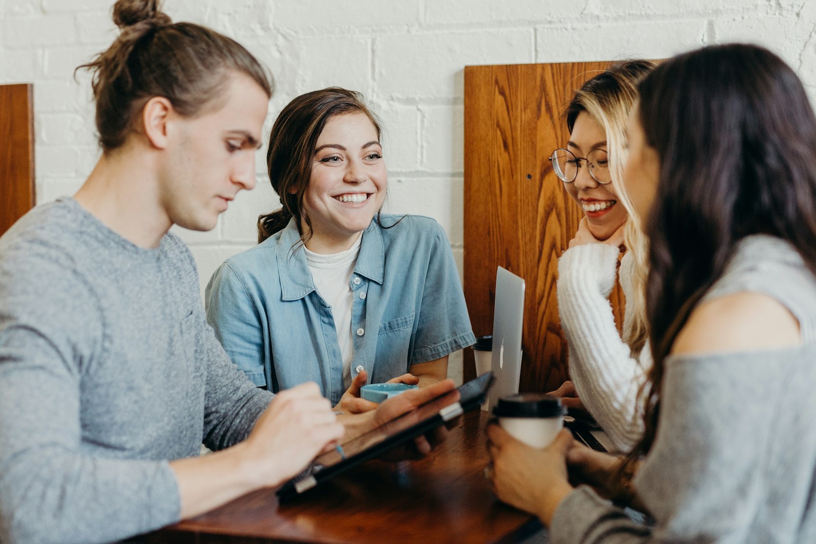 Diverse young adults collaborating and smiling